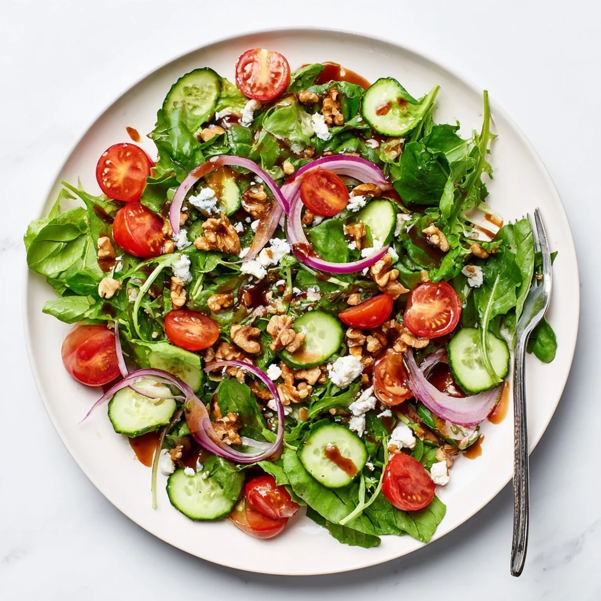 Colorful bowl of spring mix salad featuring crisp vegetables and sweet tangy balsamic honey dressing