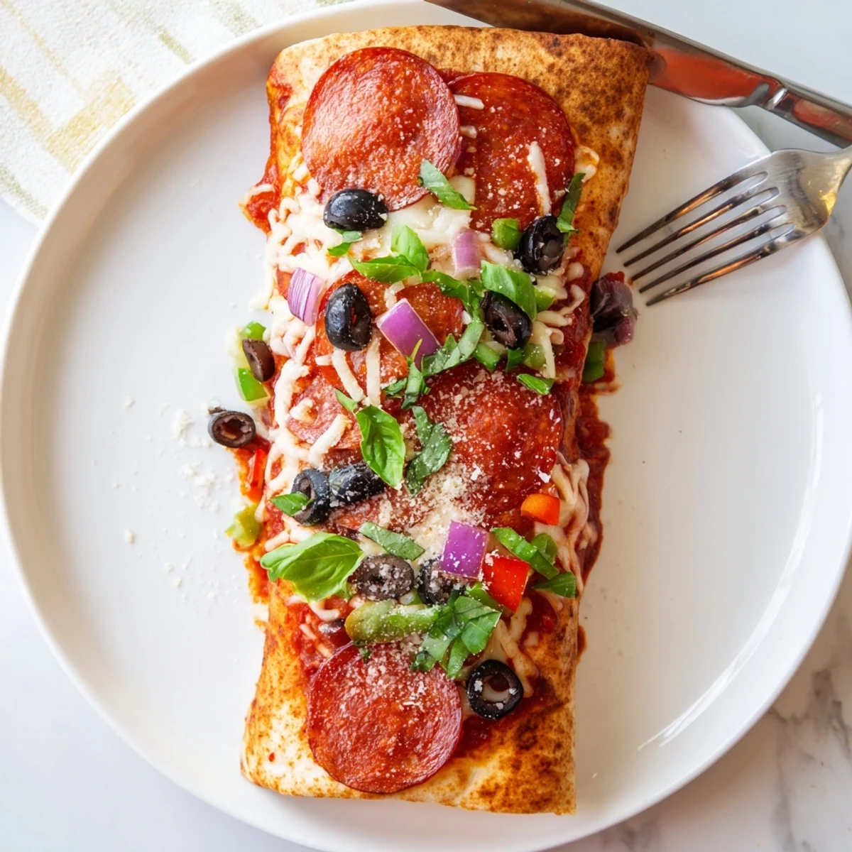 Crispy air fried pizza burritos sliced open revealing colorful bell peppers and bubbling cheese