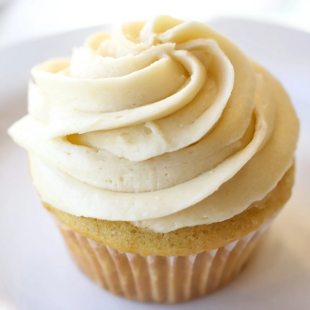 Light and fluffy vanilla cupcakes with smooth buttercream piped on colorful liners