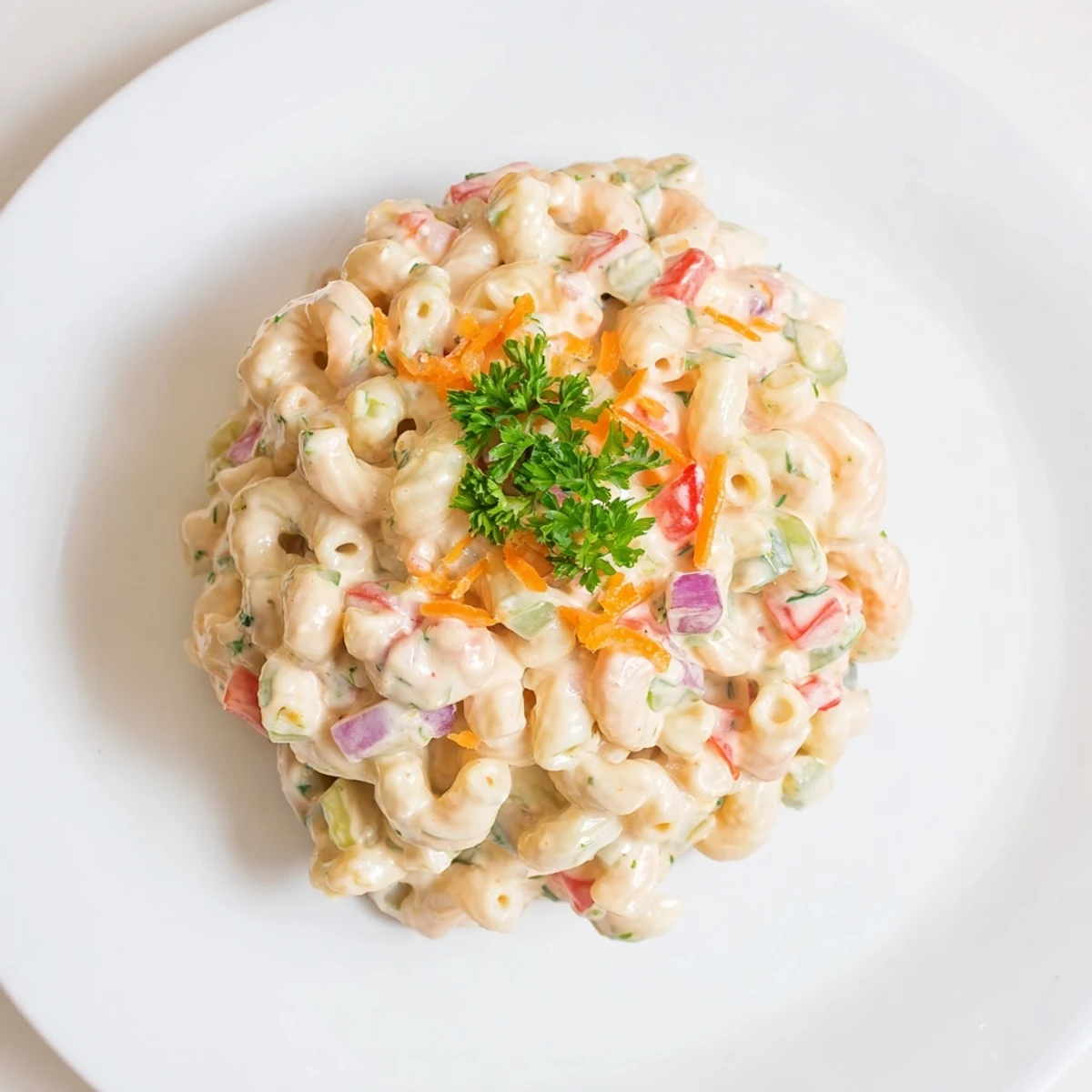 Close-up of classic macaroni salad showcasing tender pasta coated in zesty creamy dressing