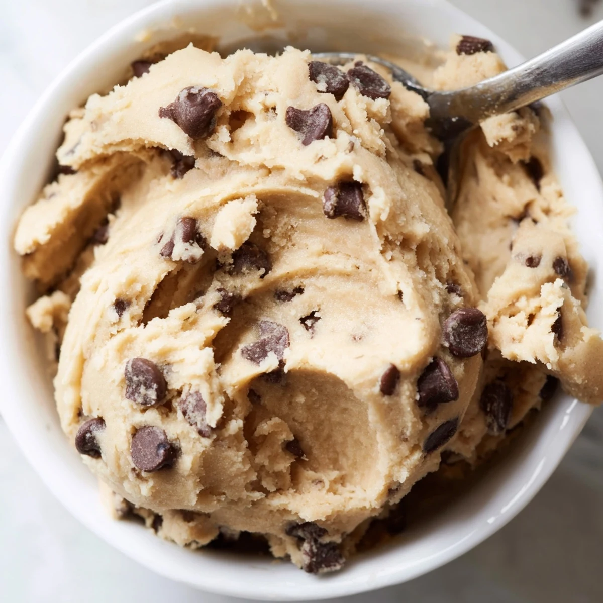 Creamy chocolate chip cookie dough scooped into balls and studded with semisweet chips