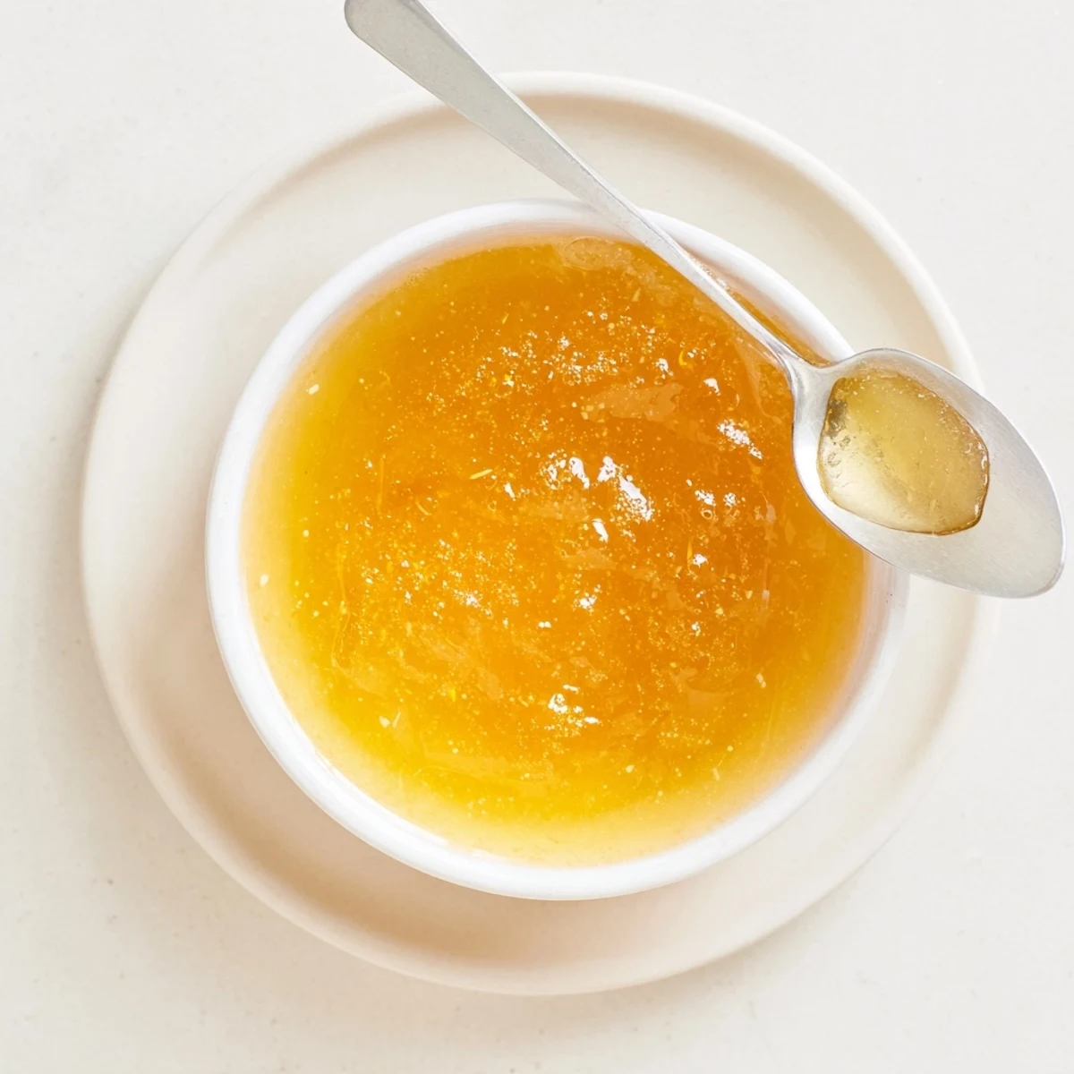 Golden homemade fresh dandelion jelly spread on a slice of toasted bread