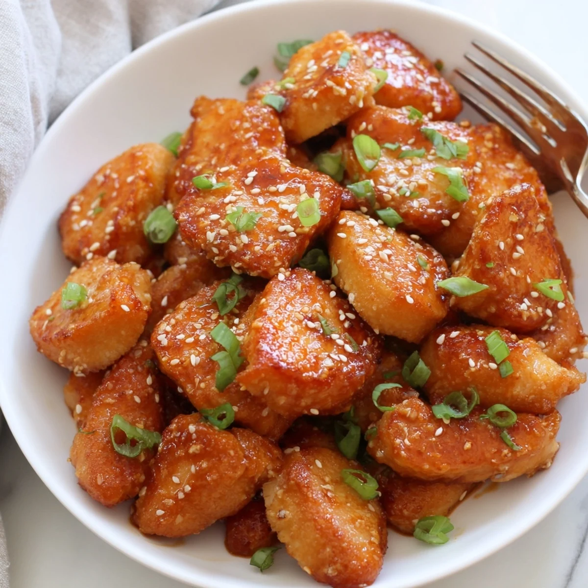 Bang Bang Salmon Bites Recipe plated over jasmine rice with green onions