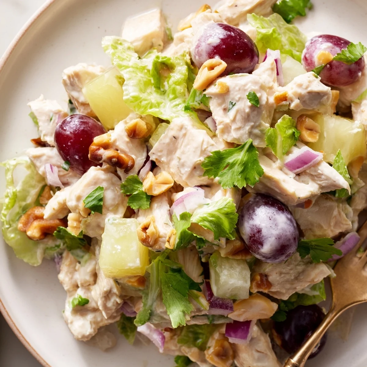 Chilled salad served in halved pineapple, bright cilantro garnish, Hawaiian Chicken Salad Recipe