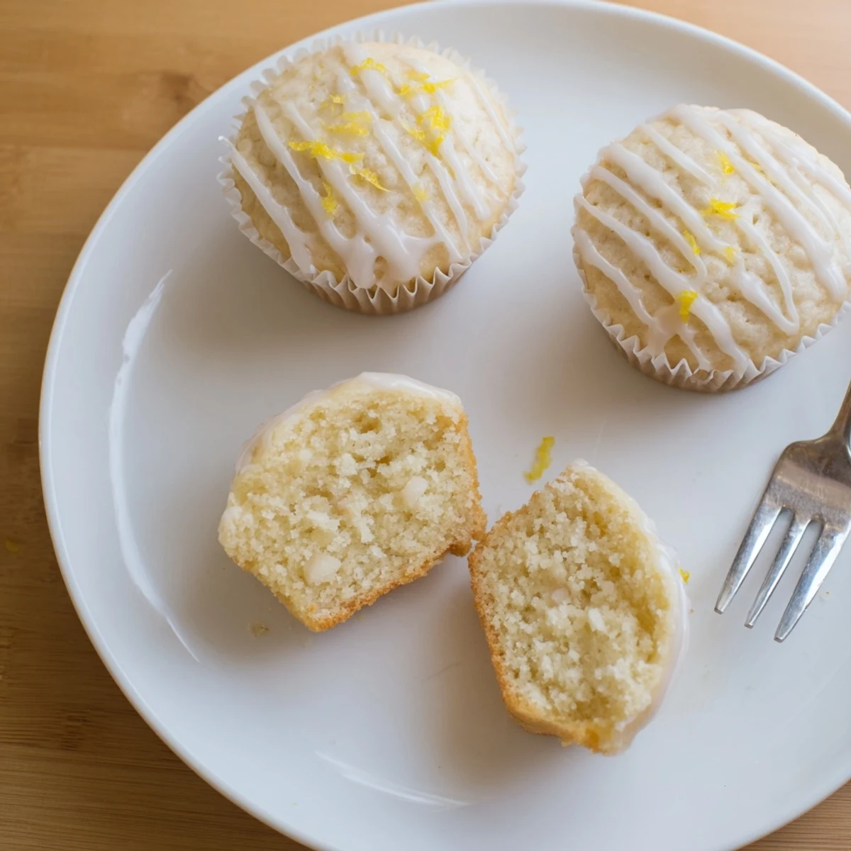 Glazed Lemon Ginger Muffins on a wire rack, shiny glaze glistening