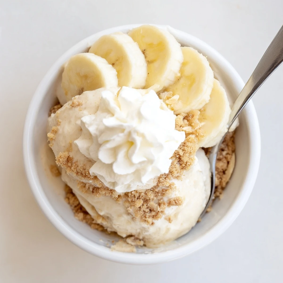 Creamy Ninja Creami Banana Cream Pie Ice Cream topped with whipped cream