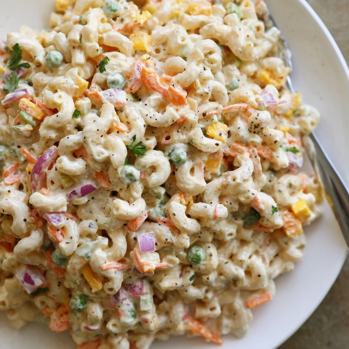 Chilled Macaroni Salad studded with peas, shredded carrots, perfect potluck bowl.