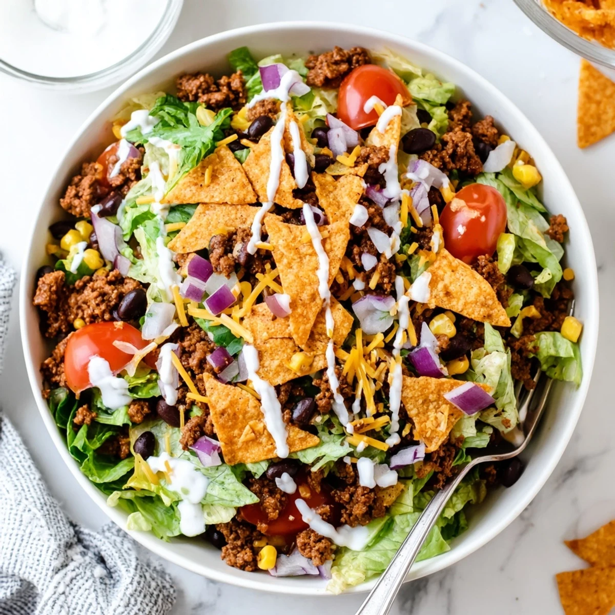 Simple Doritos Taco Salad piled high with crunchy chips, warm taco beef.