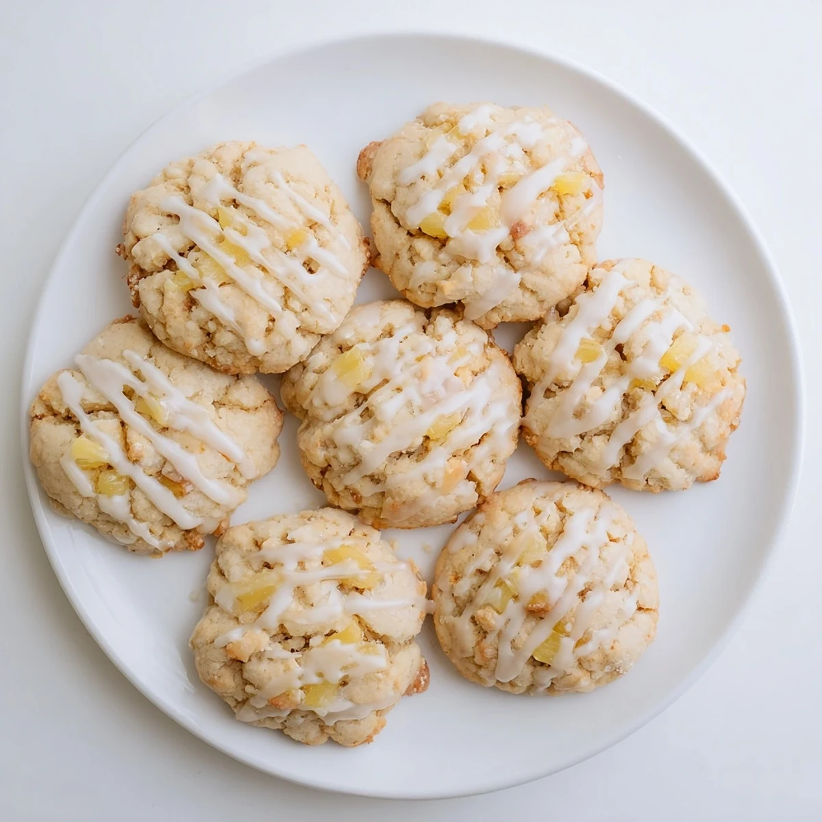 Sweet pineapple chunks visible inside these soft baked American dessert cookies on a plate