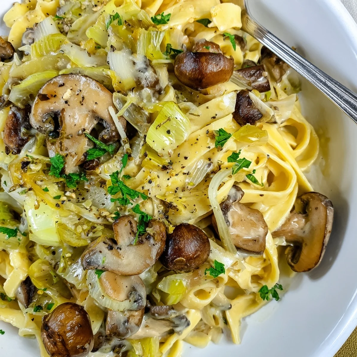 Caramelized Leek Mushroom Gruyere Pasta piled on fettuccine, creamy, golden leeks