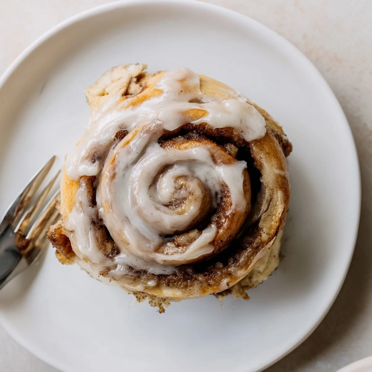 Golden Banana Bread Cinnamon Rolls with gooey cinnamon spiral, soft banana aroma.