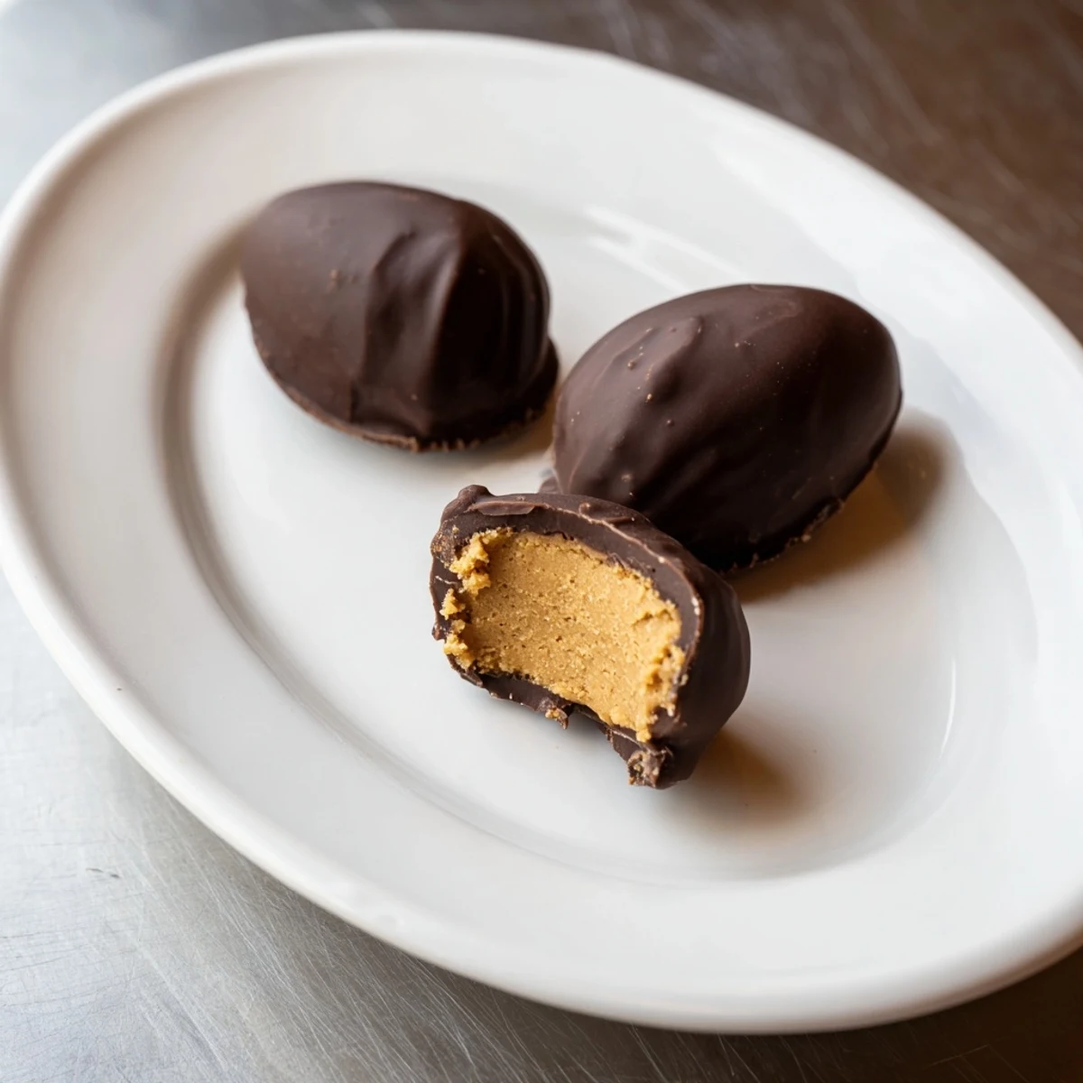 A plate of Homemade Peanut Butter Eggs garnished with sea salt, ready to serve