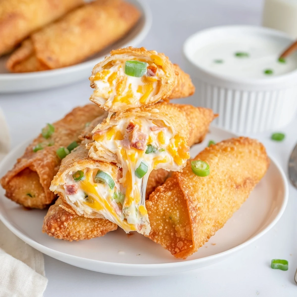 Crispy Jalapeno Popper Egg Rolls steaming golden, crunchy exterior with creamy filling