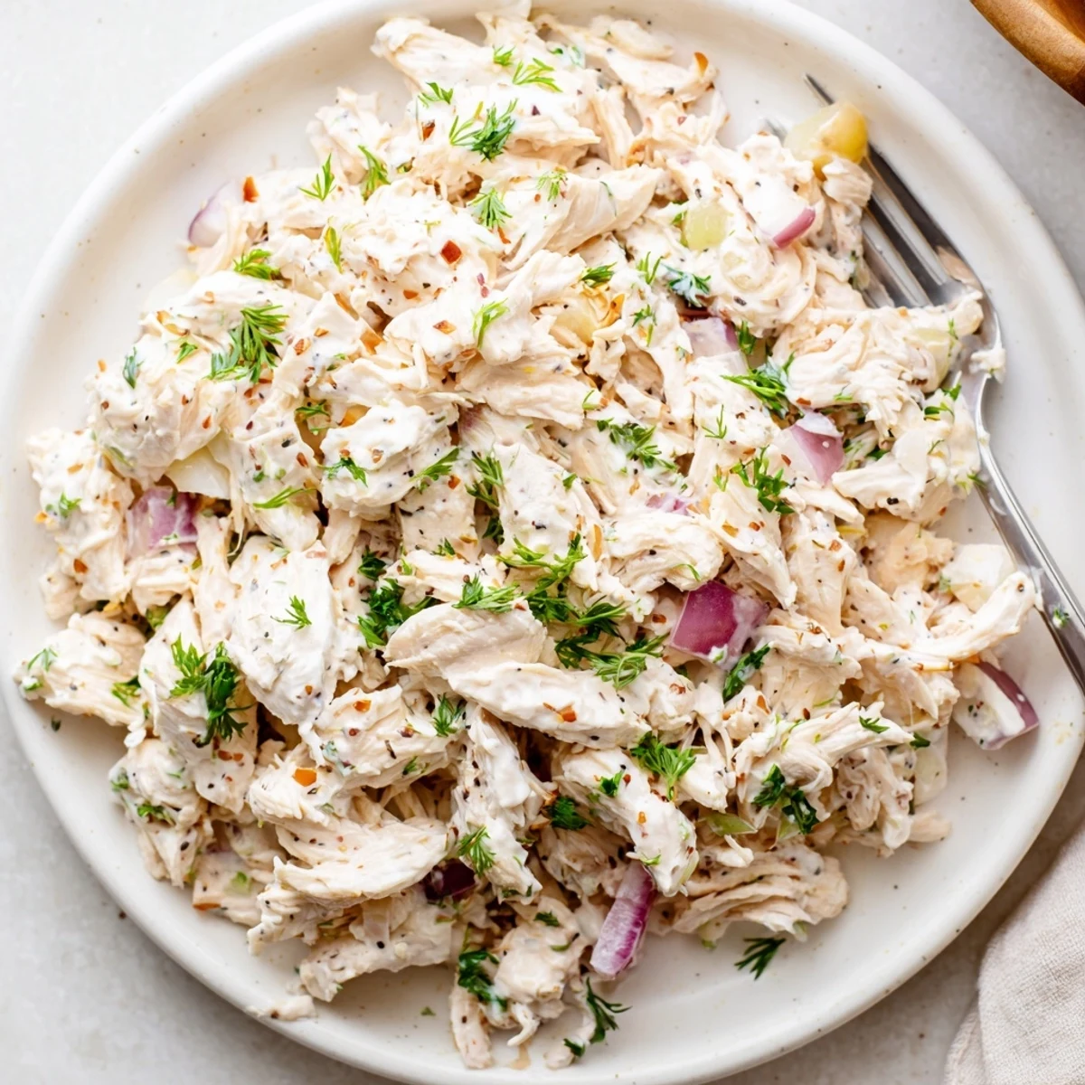 Bright lemon-dressed Healthy Greek Yogurt Chicken Salad Recipe served over greens