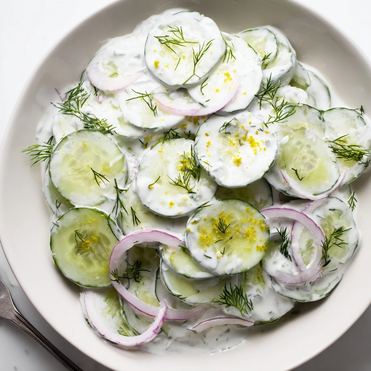 Summer-ready Tzatziki Cucumber Salad served beside grilled chicken and warm pita