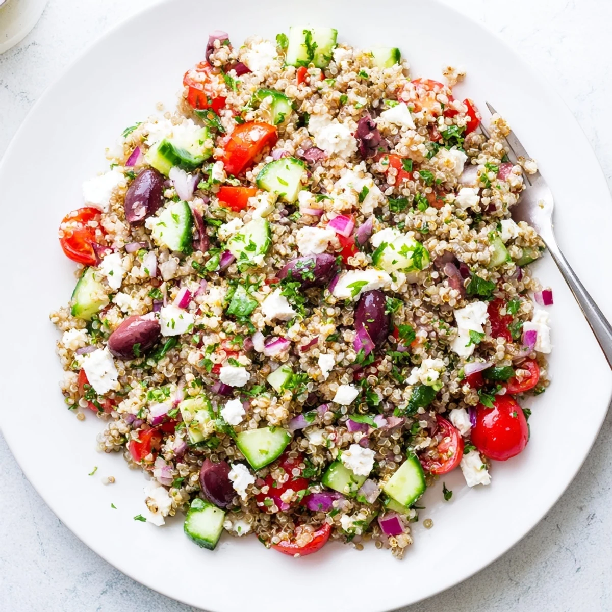 Make-ahead Greek Quinoa Salad Recipe studded with Kalamata olives and crumbled feta