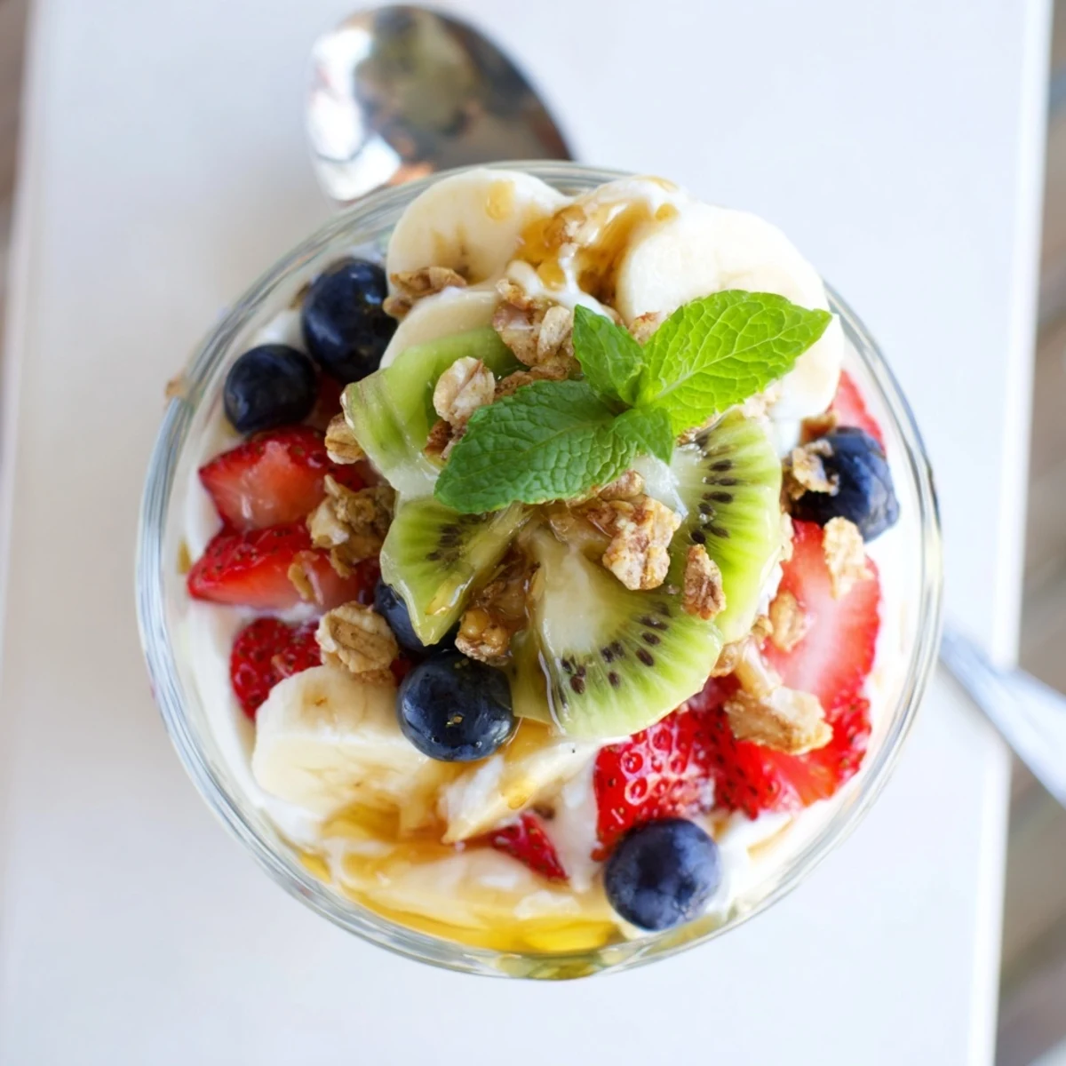 Healthy yogurt parfait recipe featuring layered Greek yogurt, granola, and mixed fresh fruits