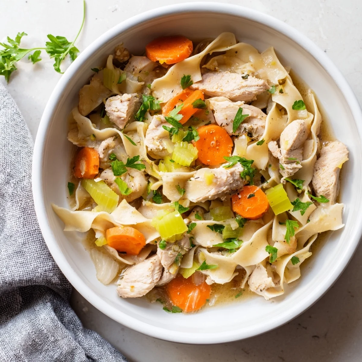 Comforting one pot chicken and noodles with carrots, celery, and tender chicken pieces cooked in one Dutch oven