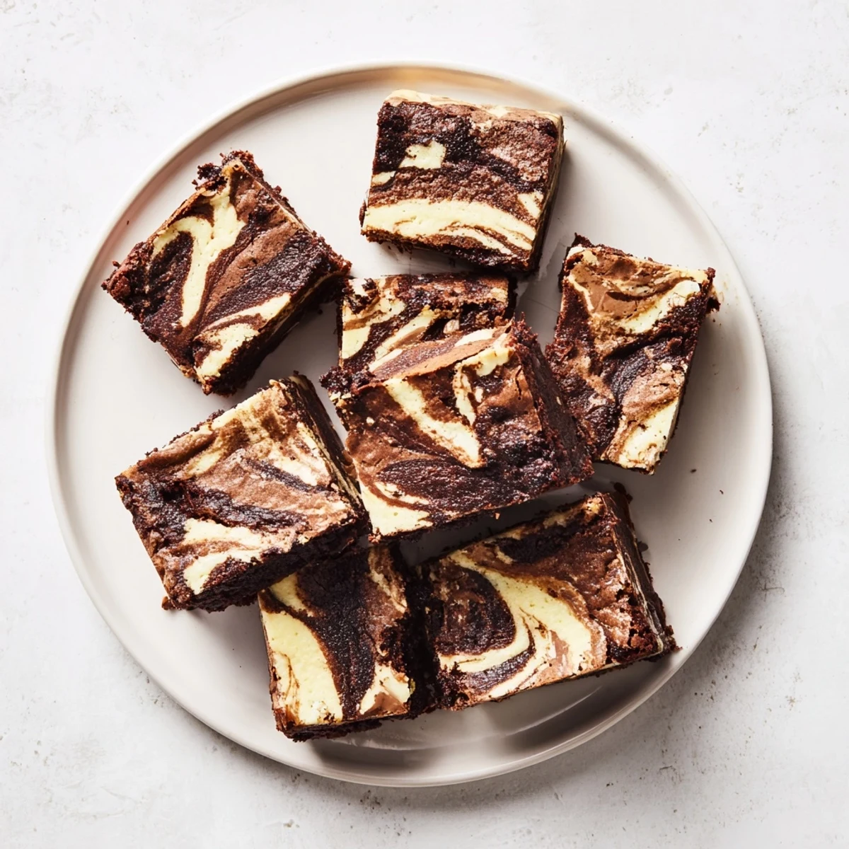 Golden sourdough cheesecake brownie bars sliced into squares with marbled chocolate and vanilla patterns