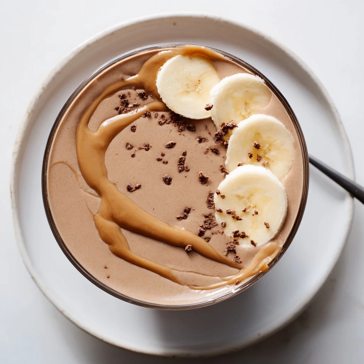 Velvety Chocolate Peanut Butter Banana smoothie chilled, garnished with a peanut-butter drizzle