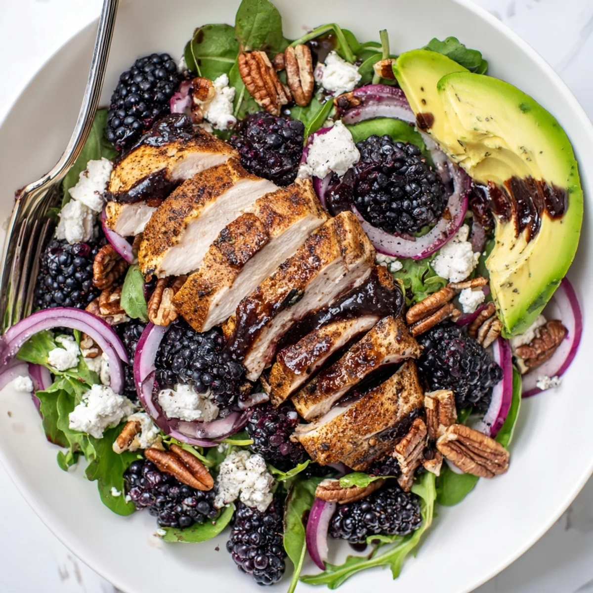 Plated Sweet Tangy Blackberry Chicken Salad Recipe with toasted pecans, creamy goat cheese.