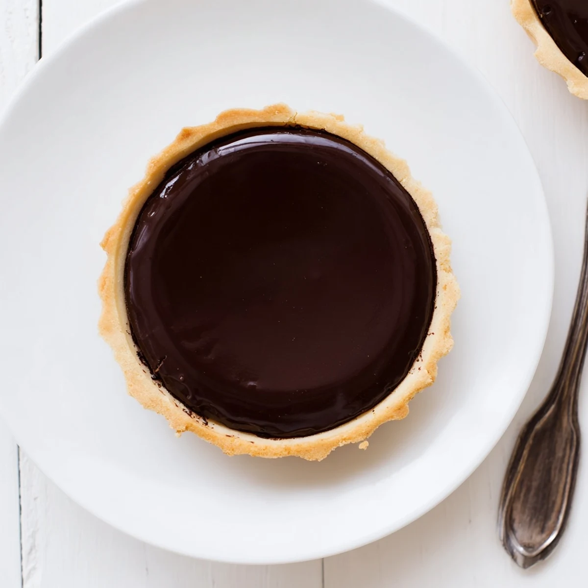 Creamy chocolate French dessert baked in delicate pastry shell dusted with cocoa powder