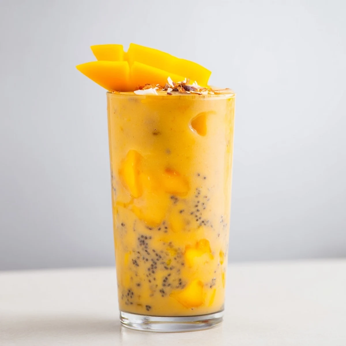 Creamy mango pineapple protein smoothie blended with coconut milk and orange juice