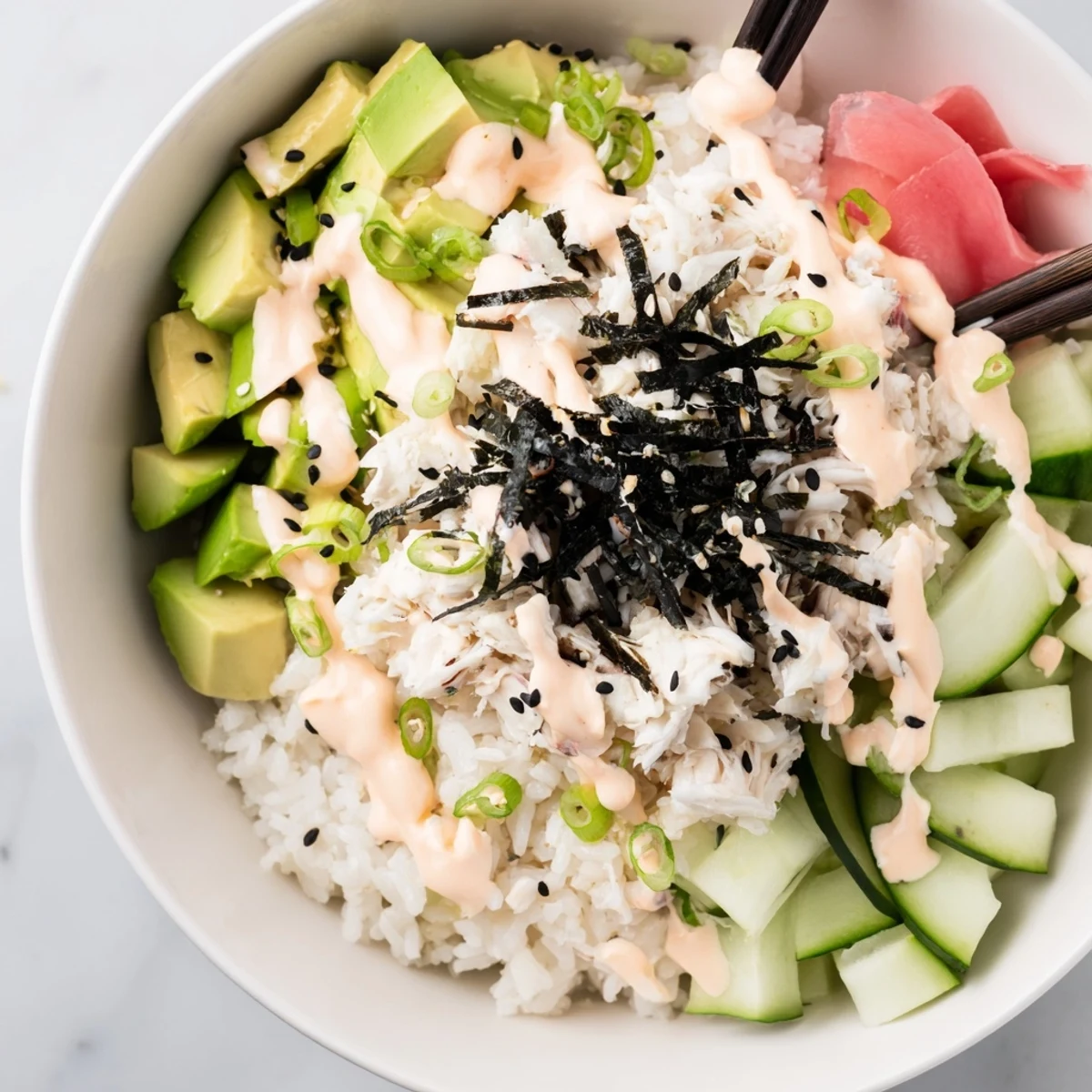 Colorful California Roll Sushi Bowl featuring seasoned rice topped with crab avocado cucumber nori strips