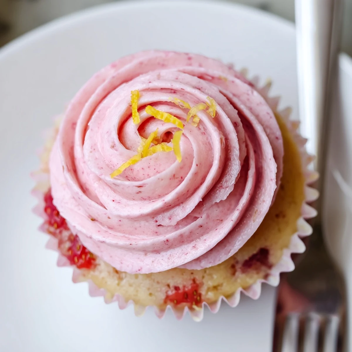 Strawberry Lemonade Cupcakes with swirls of pink buttercream, bright lemon zest