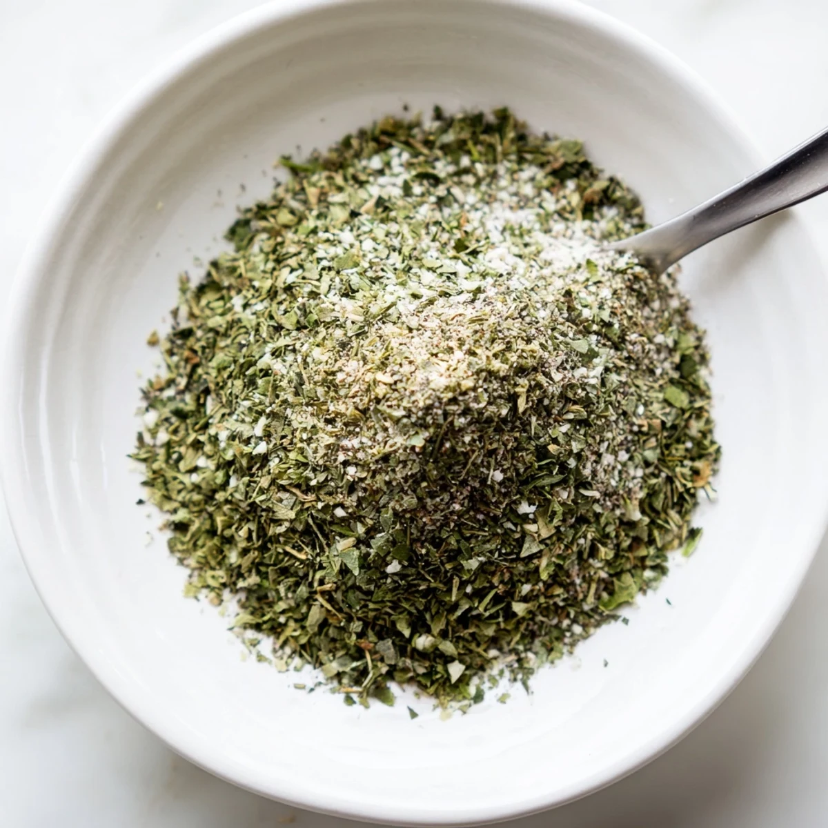 Spoonful of Dehydrated Tzatziki Seasoning Mix ready to stir into yogurt