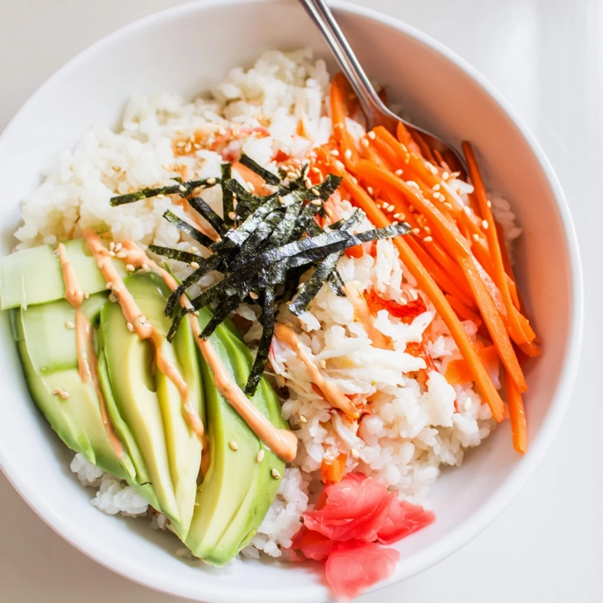 California Roll Sushi Bowls with creamy avocado, bright cucumber, and toasted sesame seeds
