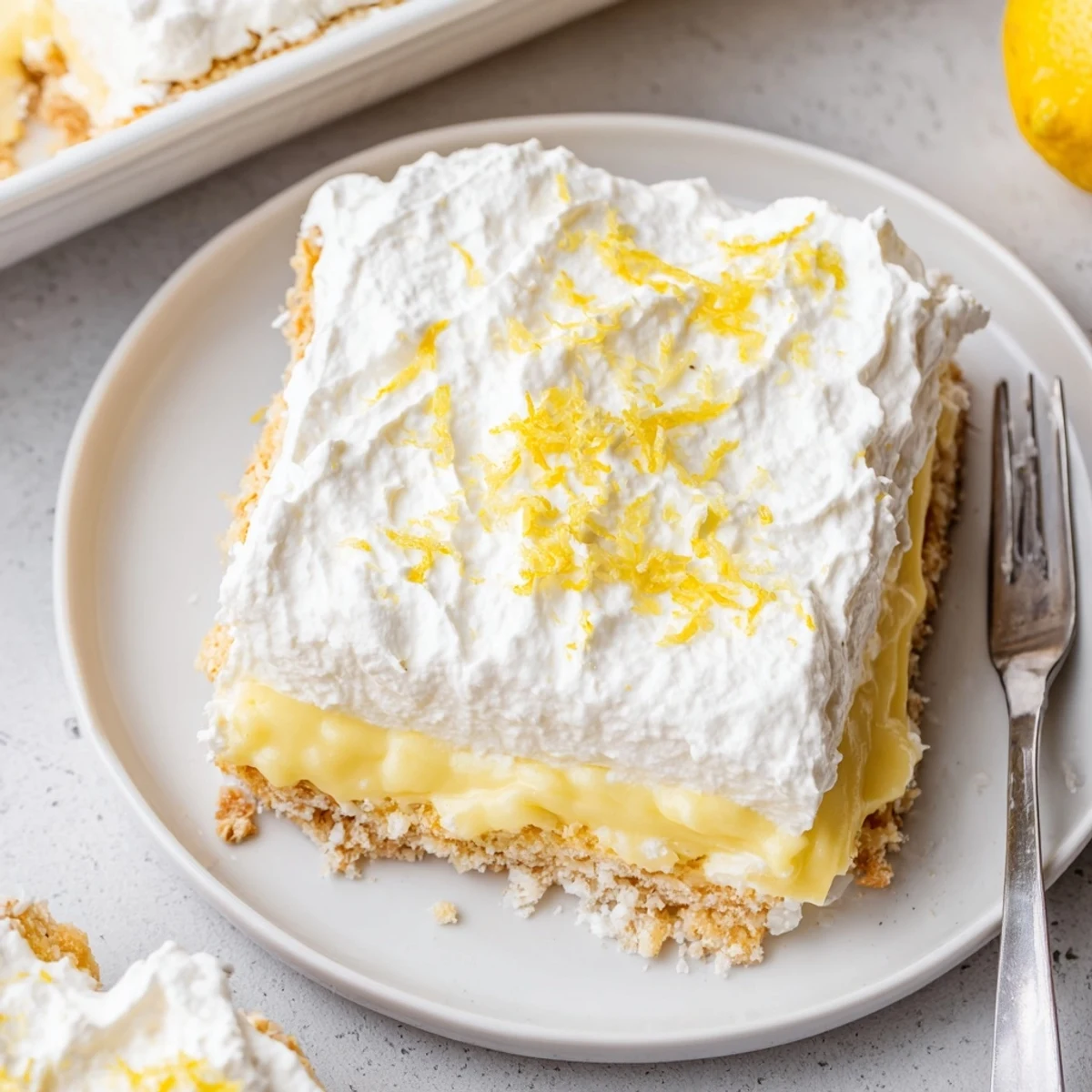 Lemon Lush Cake with creamy lemon layer and fluffy whipped topping, chilled