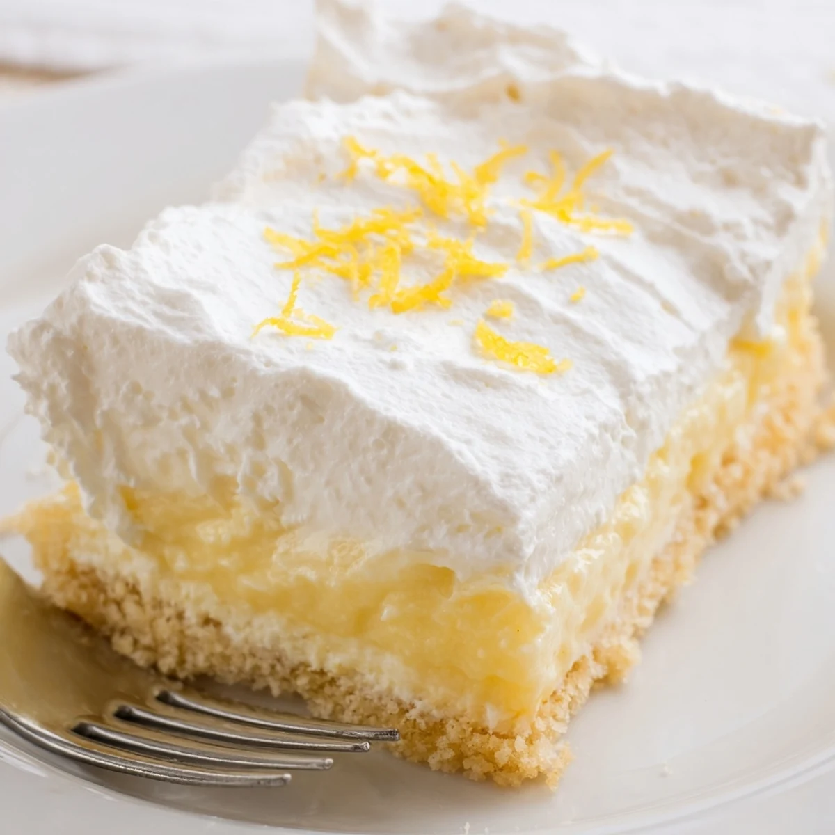 Chilled Lemon Lush Cake layered dessert, tangy lemon pudding and cream cheese