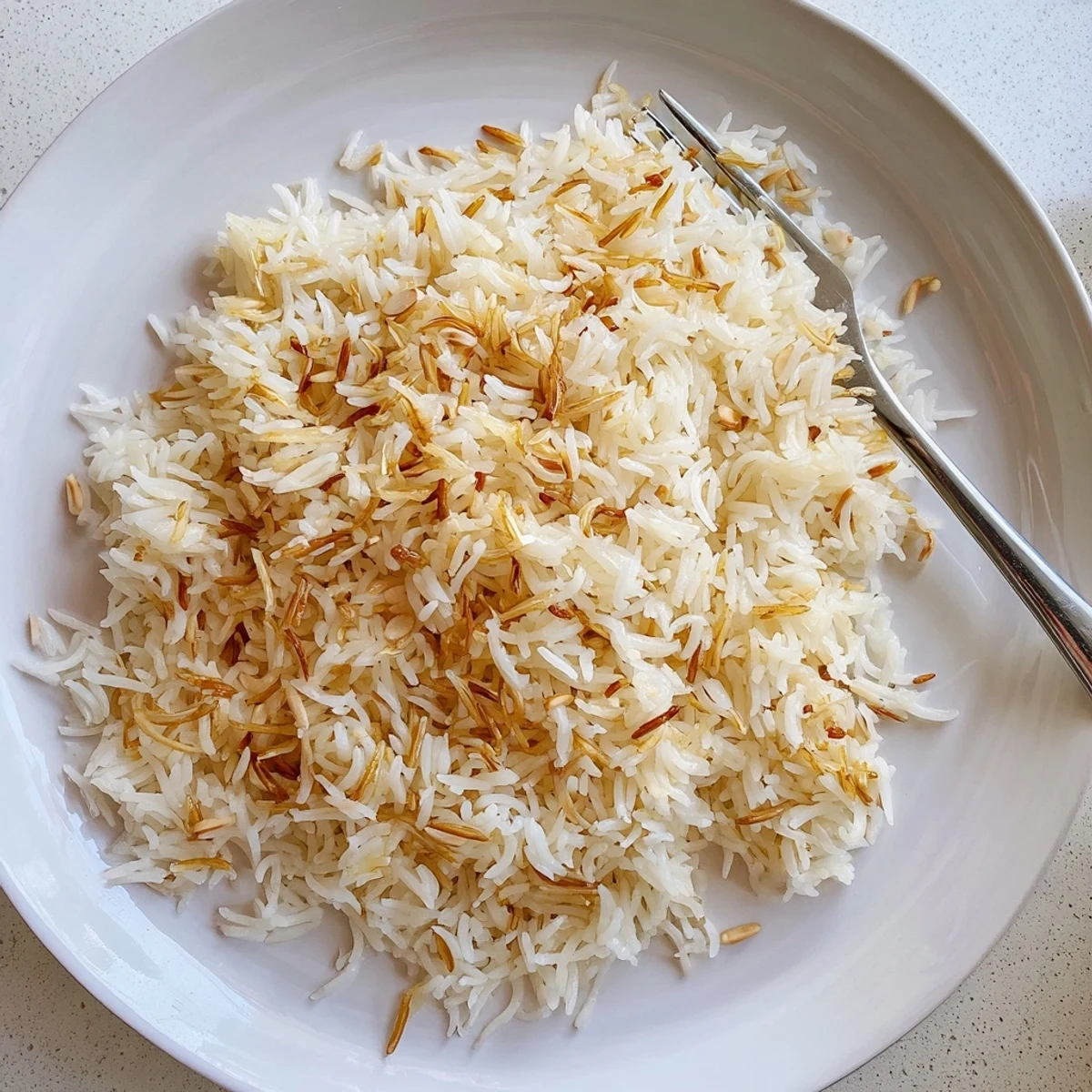 Steaming bowl of Lebanese Rice with crispy noodles perfect for weeknight dinners