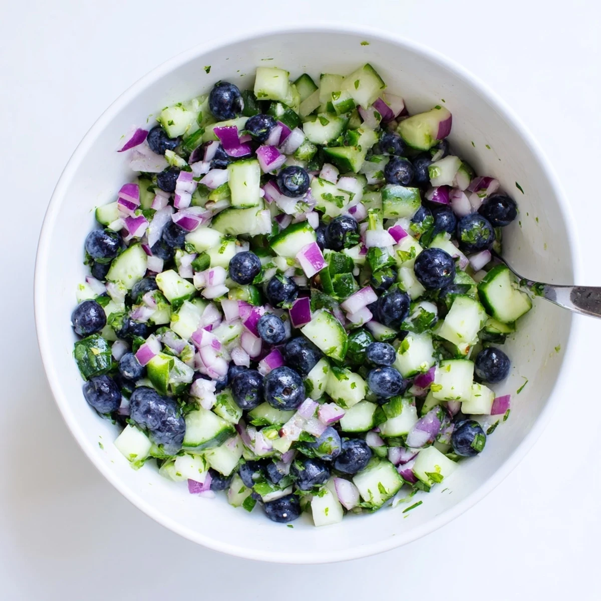 Colorful blueberry cucumber salsa topped with cilantro and a squeeze of lime