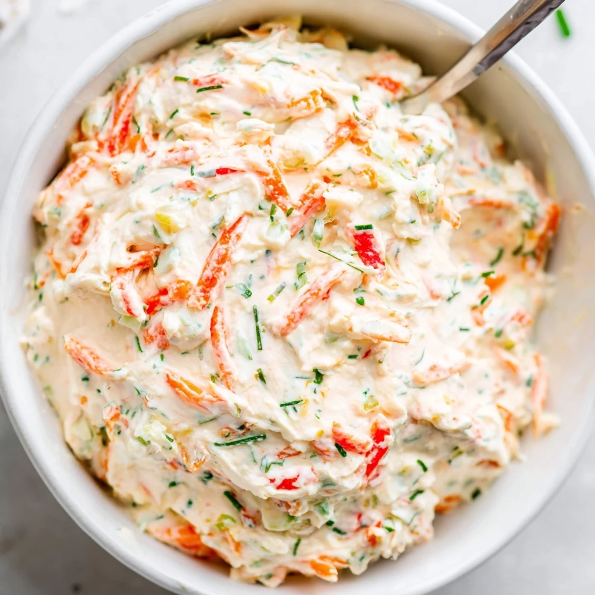 Vibrant garden vegetable spread in a bowl surrounded by toast and crisp veggies