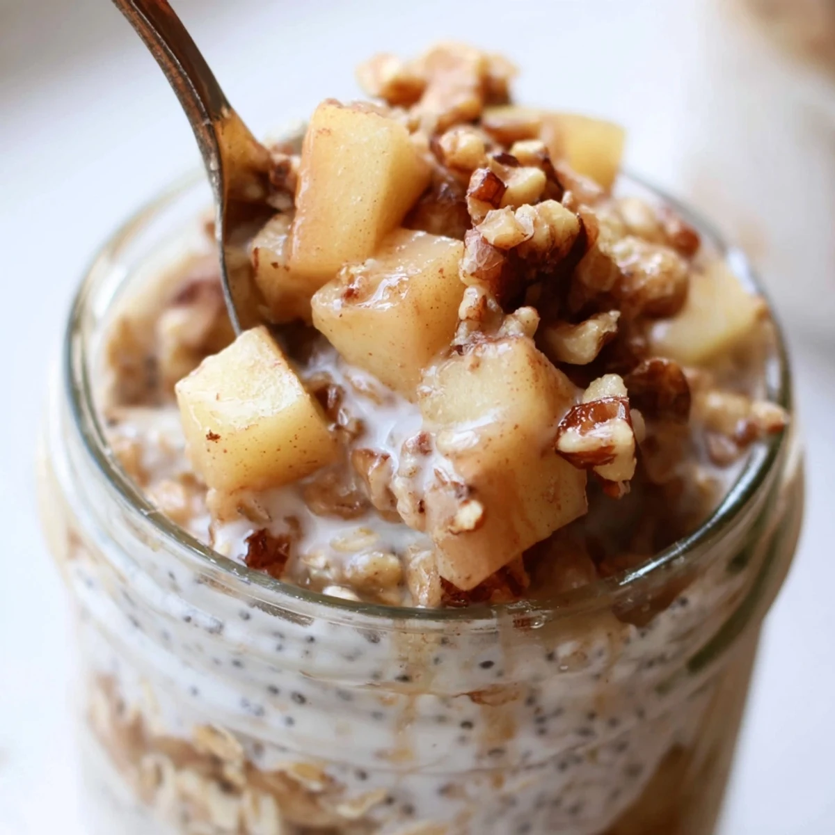 Apple Crumble Overnight Oats served cold with visible spice-kissed apple chunks and sprinkled topping