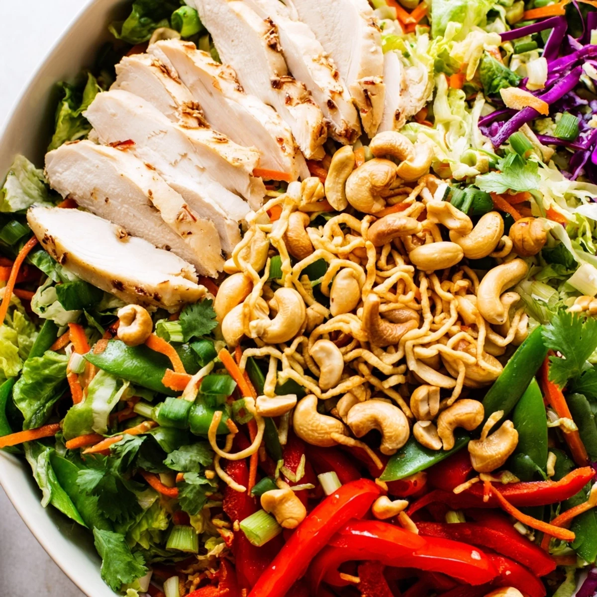 Crunchy Chicken Cashew Crunch Salad with julienned vegetables and sliced chicken breast