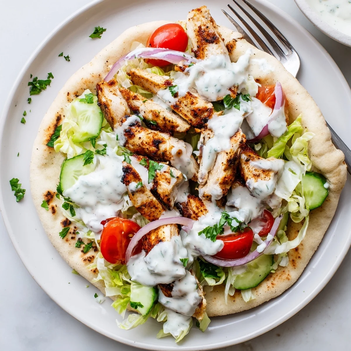 Warm Flavor Packed Chicken Pitas drizzled with creamy yogurt tahini sauce