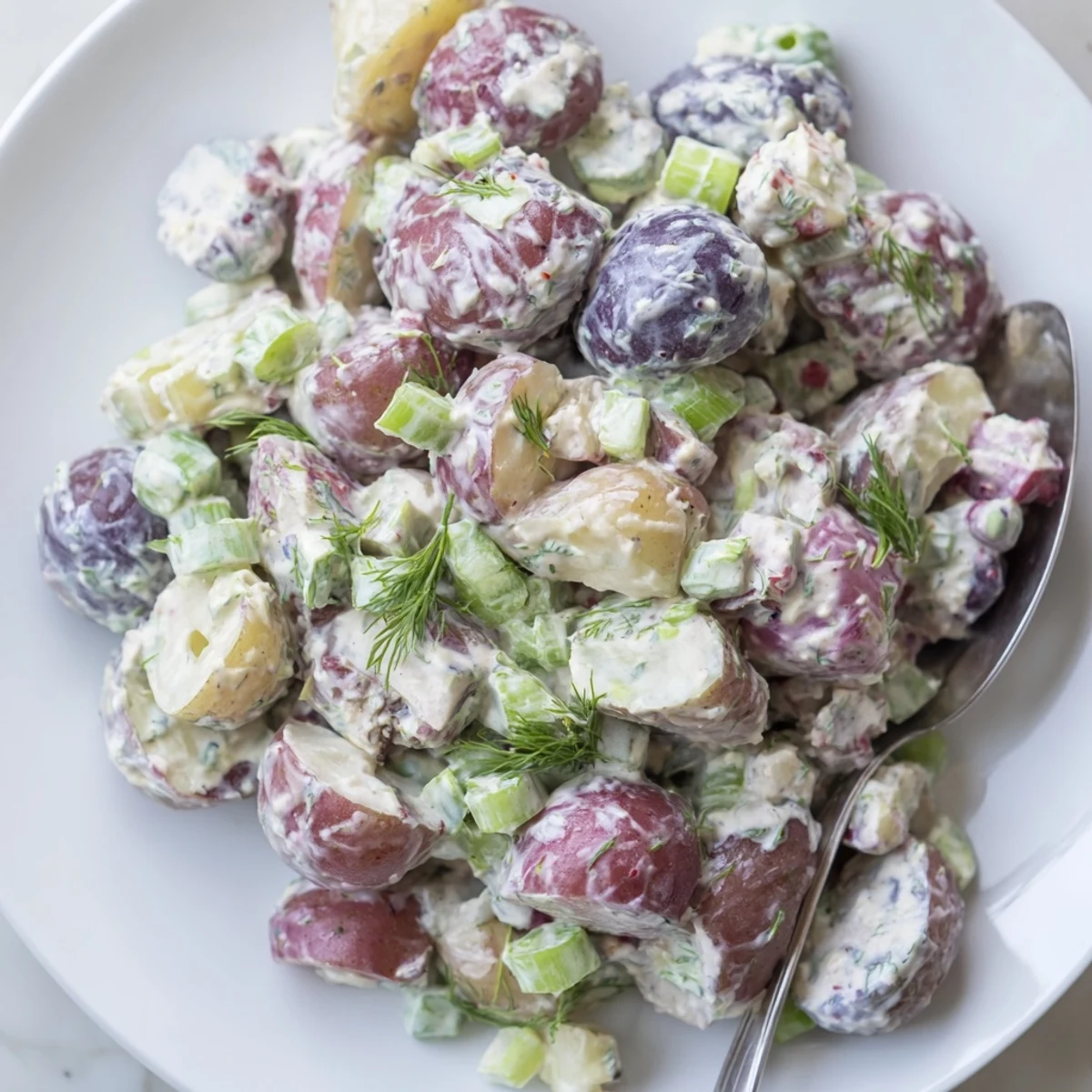 Vibrant Red White Blue Potato Salad served chilled at a festive summer picnic