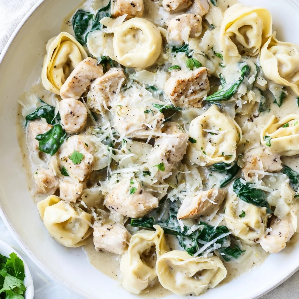 Golden seared chicken and cheese tortellini tossed in a silky garlic Parmesan cream sauce