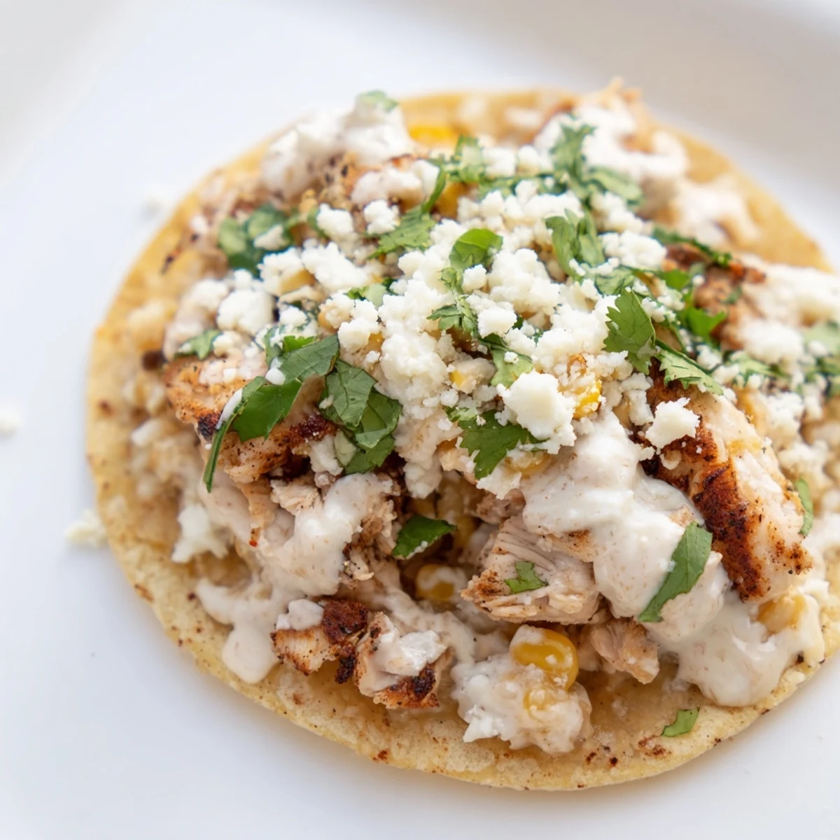 Delicious Street Corn Chicken Tacos featuring charred corn, savory chicken, and tangy lime crema.