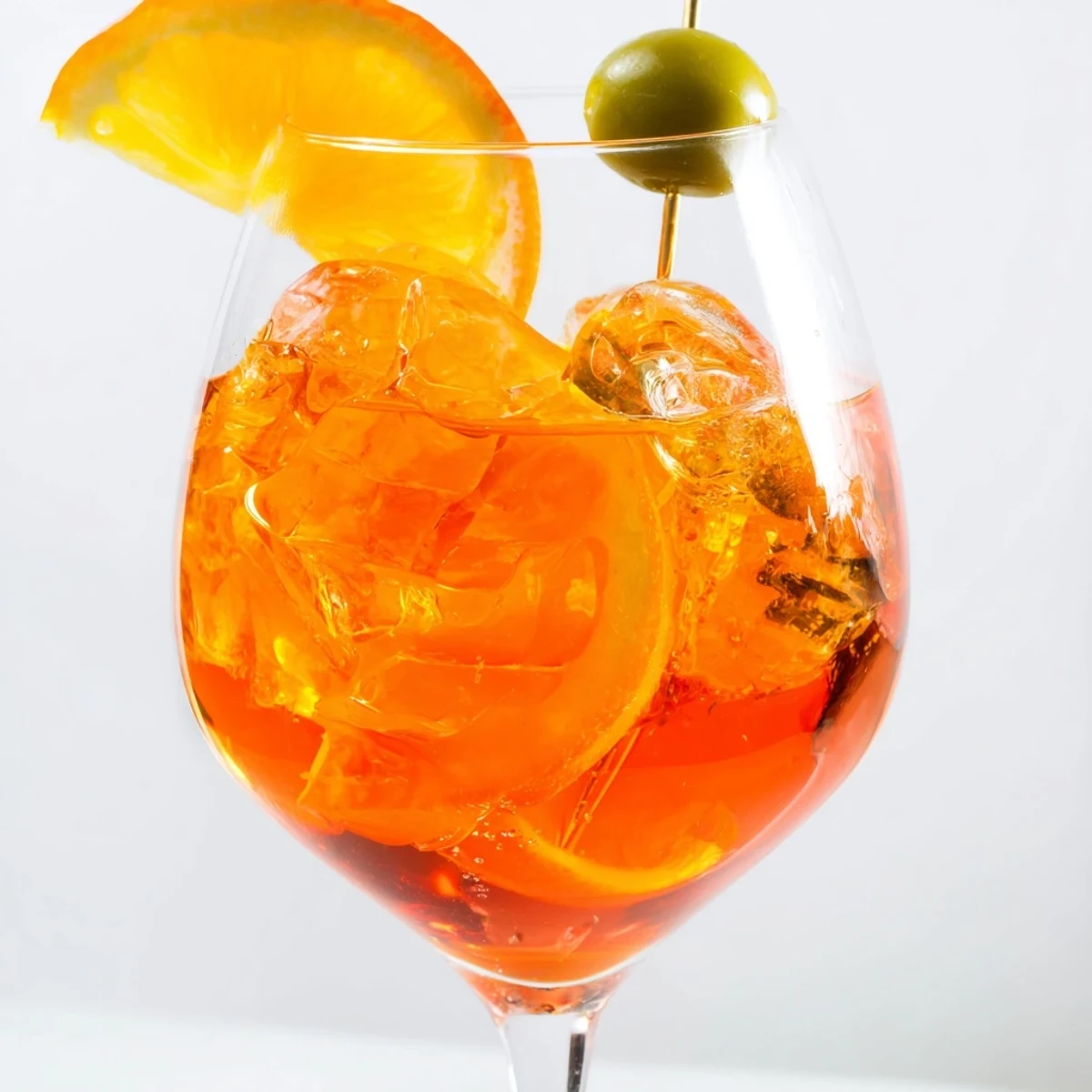 Refreshing Spritz recipe showing fizzy orange drink in a wine glass.  
