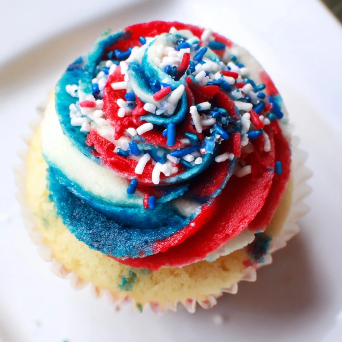 Festive vanilla cupcakes topped with swirled buttercream for Independence Day.  