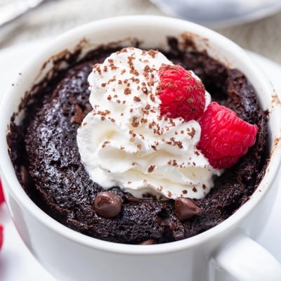 Fudgy gluten free chocolate mug cake fresh from the microwave with melty chips